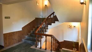 A staircase with wooden railings and a sign indicating the 3rd floor. - Kumaon Roop Resort (Kosiyakutoli)