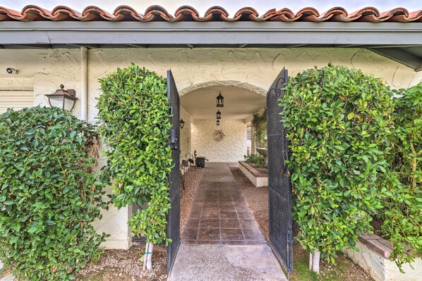 Enter a serene oasis, surrounded by lush foliage and a beautifully designed entrance.