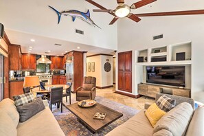 Relax in this stylish living space with a large flat-screen TV, comfortable sofa, and dining area.