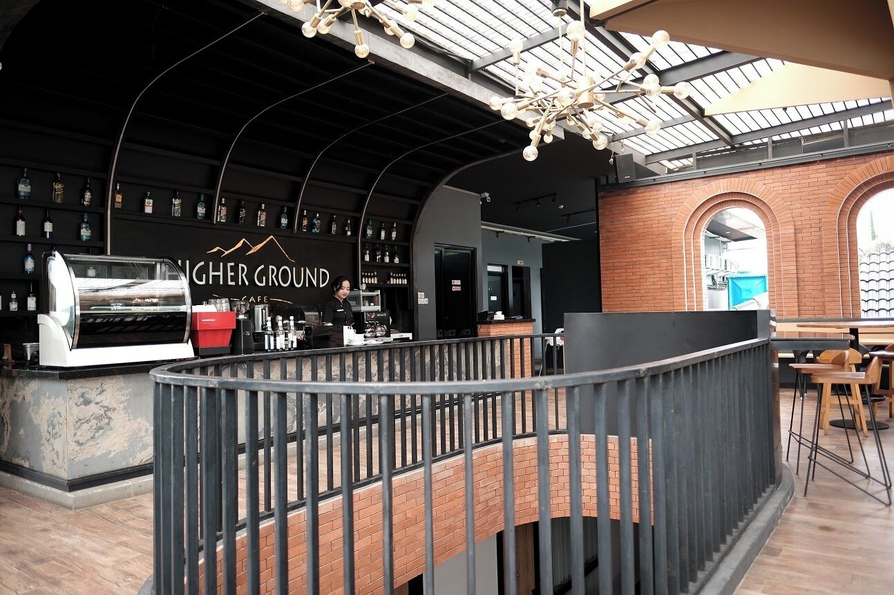 An interior with a bar area, a seating area, and a visible staircase.