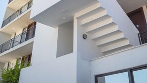 A multi-story building with balconies and a modern architectural design.