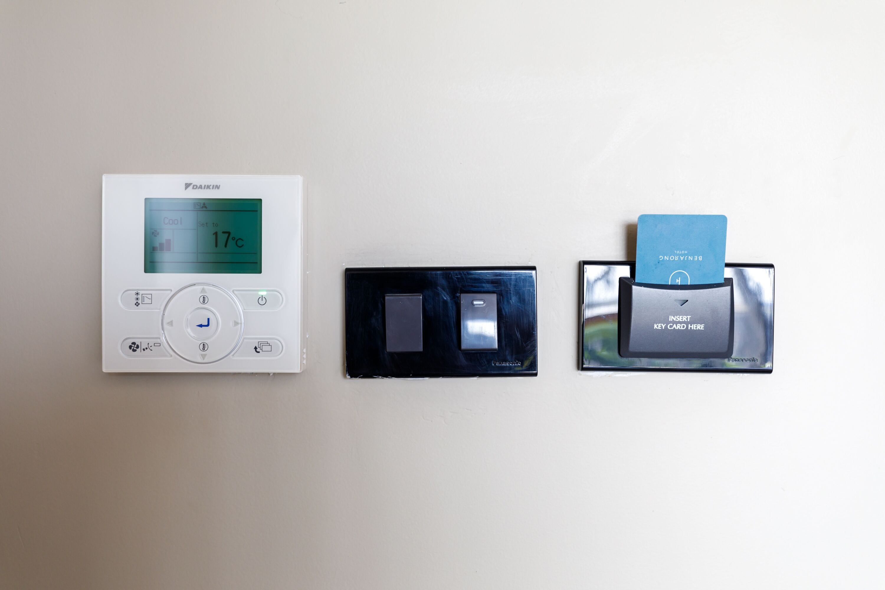 Three devices: a thermostat, a remote control, and a card reader.