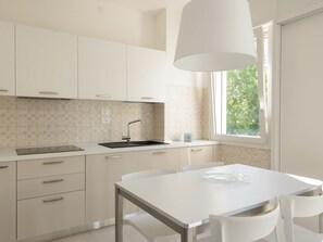 Fridge, dishwasher, highchair, cookware/dishes/utensils