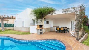 A poolside area with a barbecue and outdoor seating. - Villa Mar i Cel by Interhome (L'Ametlla de Mar)