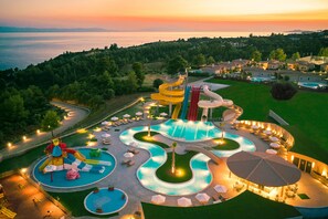 A resort with a water park, swimming pools, and a sunset view. -  Zeus Eleva Ajul (Kassandra)