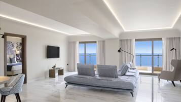 Executive Suite, Sea View | Living area | LCD TV, books