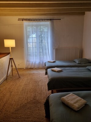 A bedroom with two beds, a floor lamp, and a window with sheer curtains. - Magnificent Mas Provençal in the southern Luberon (Lauris)