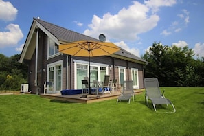 Enjoy a comfortable outdoor living space with a large deck and patio area.