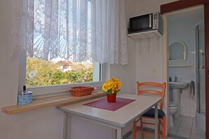 Cozy retreat with a kitchenette, window view, and comfortable seating area.