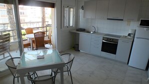 A modern kitchen with white cabinets, a built-in oven, and a coffee maker. - Beautiful renovated apartment for 4 with private parking in Roses (Roses)