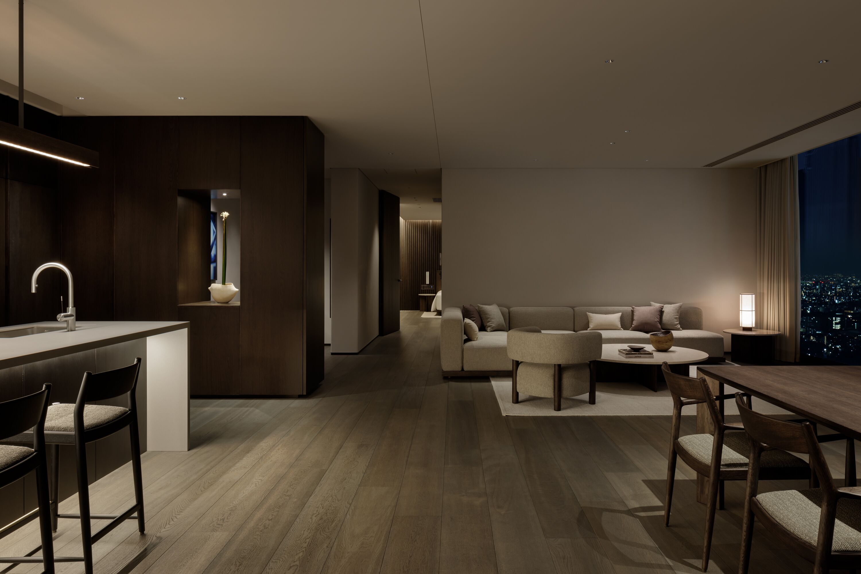 A modern living room with a sofa, coffee table, and dining area.