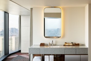 A modern bathroom with a large mirror, two sinks, and a view of the city through large windows. - HOTEL GROOVE SHINJUKU, A PARKROYAL Hotel (Tokyo)