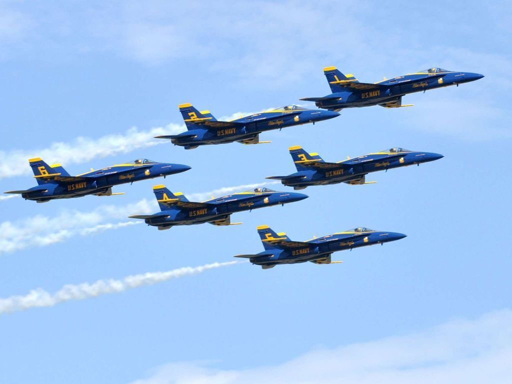 Four US Navy Blue Angels aircraft flying in formation.