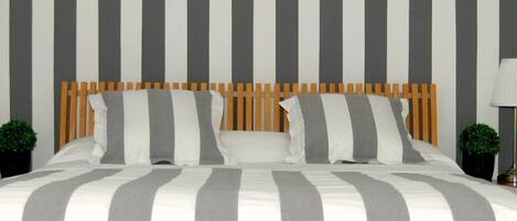 Cubrecamas, escritorio y espacio para trabajar con laptop