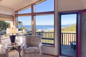 Enjoy ocean views from the large window, relax in the chair, and work at the table with a lamp.