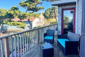 Relax on the deck with two comfortable chairs and a small table, offering a view of the surrounding neighborhood.