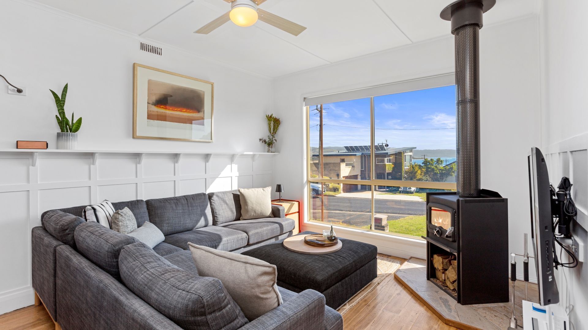 The living room looks inviting with its comfy couches, flat-screen TV, and Wi-Fi. 