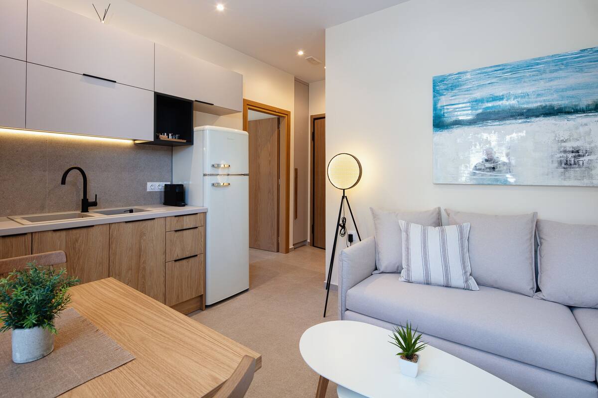 A modern kitchen with a built-in refrigerator, wooden cabinets, and a countertop.