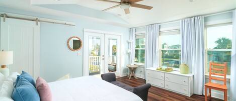 One of two light-filled primary suites with large windows and balcony access. A bright, peaceful space designed for comfort and relaxation.