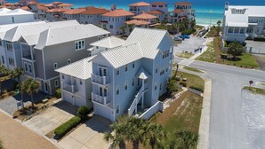 A coastal residential area with multiple two-story houses featuring balconies and a clear view of the ocean. - New to Dune Allen Realty!!! (Santa Rosa Beach)