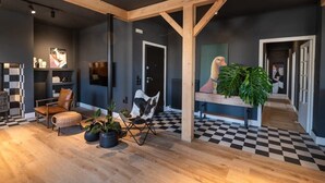 A modern interior with a checkered floor, wooden beams, and potted plants. - City's Best-Kept Secret, Chic & Luxe Getaway (Kalamata)