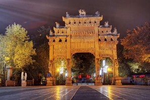 A large, ornate gate with intricate carvings and a traditional design, likely serving as an entrance to a historical or cultural site. - Holiday Inn Oriental (Yuxi People's Hospital Shuixi Park Branch) (Qianxi)