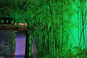 A bamboo forest with a structure in the foreground. - Holiday Inn Oriental (Yuxi People's Hospital Shuixi Park Branch) (Qianxi)