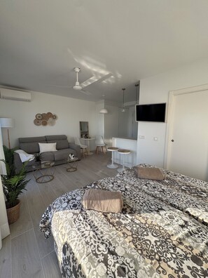 A modern living room with a sofa, coffee table, and a patterned bedspread. - Apartment 853 on the waterfront with a view of the ocean (Marbella)