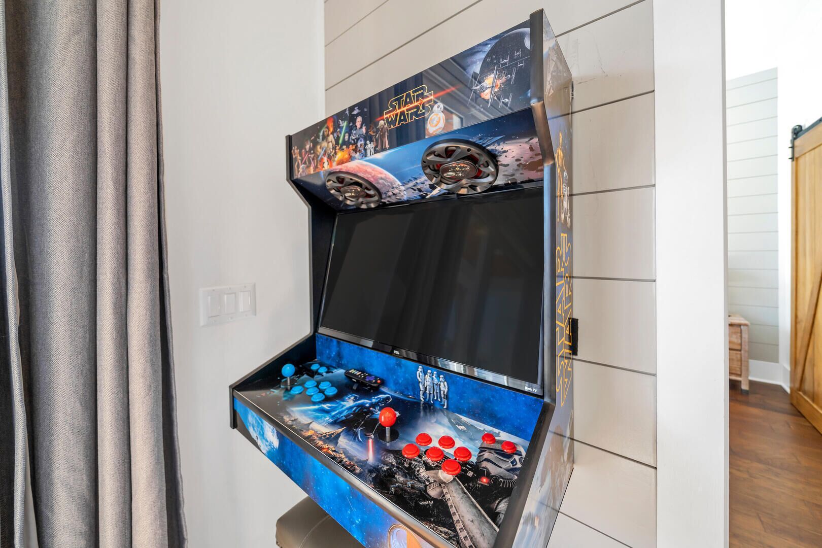 A Star Wars-themed arcade machine with a large screen and joystick controls.