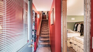 A narrow hallway with a carpeted staircase leading to a bedroom with a bed and a closet. - Maybe the best location on the mountain! Pool, hot tub, sleeps 6! (Newry)