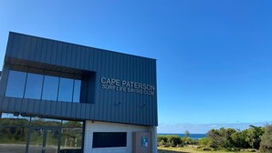 A modern building with the sign "Cape Paterson Surf Life Saving Club" on the facade. - Beachfront at Cape Paterson (Cape Paterson)