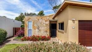 Stunning home with a beautifully maintained garden and entryway.