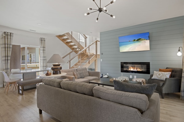 Living room offers plenty of seating around an electric fireplace and ROKU TV