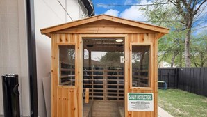 A wooden sauna structure with a sign indicating safety instructions. - Panoramic 4BR/3B Home with Pool, Grill, Sauna & Game Room (Dallas)