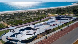 A skate park with multiple ramps and a beach in the background. - Unit 64 Seafront Estate (Jurien Bay)
