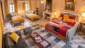 A hotel room with two beds, a sofa, a fireplace, and a checkered floor. - Cosy Castle with Pool in Onlay (Onlay)
