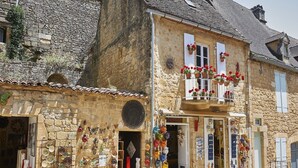 A stone building with a shop on the ground floor displaying pottery and ceramics. - Villa in Lanzac with Private Garden (Lanzac)