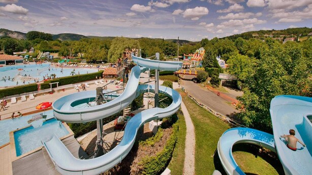 A water park with multiple slides and pools, surrounded by greenery and hills. - Villa in Lanzac with Private Garden (Lanzac)