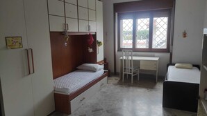 A compact room with a bed, a desk, and a wardrobe. - Apartment between Herculaneum and Pompeii at fields of Vesuvius (Torre del Greco)