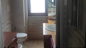 A compact bathroom with a toilet, sink, and a mirror cabinet. - Apartment between Herculaneum and Pompeii at fields of Vesuvius (Torre del Greco)
