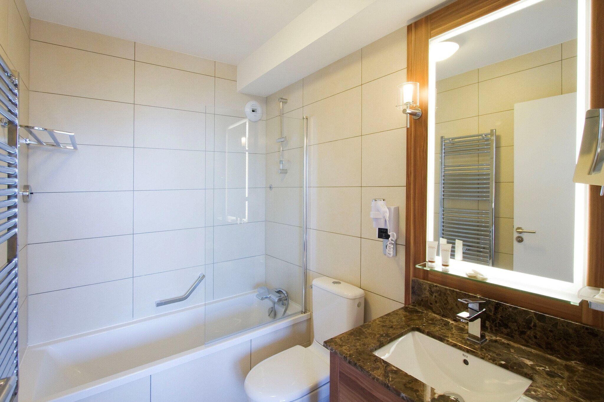 A bathroom with a bathtub, toilet, and sink.