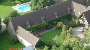 A large building with multiple rooms, a swimming pool, and a parking area. - Holiday Home in Quend-Plage near Forest (Quend-Plage)