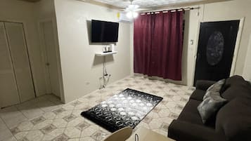 Basic Triple Room | Living area | 50-inch Smart TV with cable channels, TV