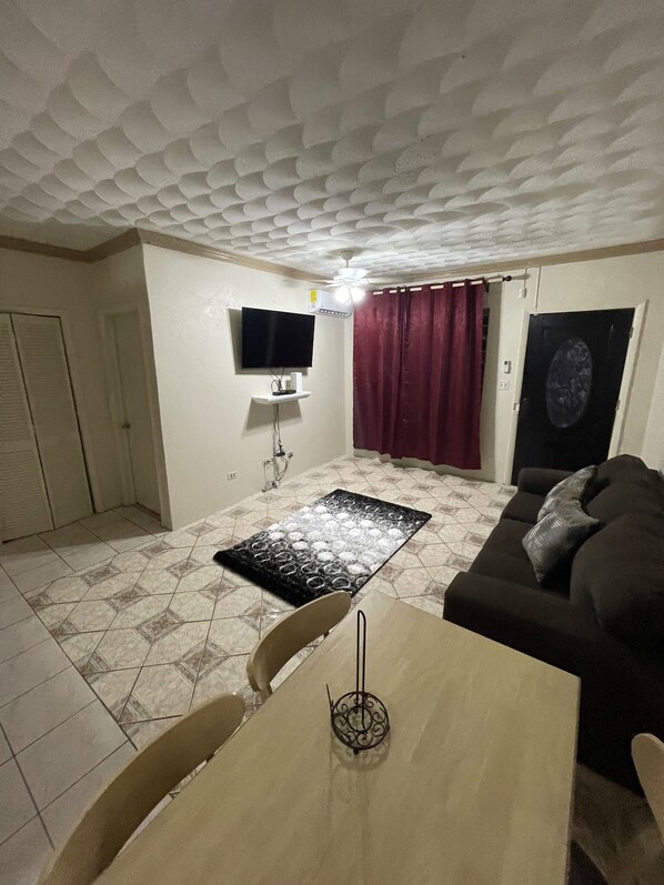 Basic Triple Room | Living area | 50-inch Smart TV with cable channels, TV - Wells Property (Nassau)