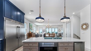 A modern kitchen with stainless steel appliances, a large island, and pendant lighting. - All open summer weeks just discounted up to 25%! Book now for lowest rates of th (Cape San Blas)