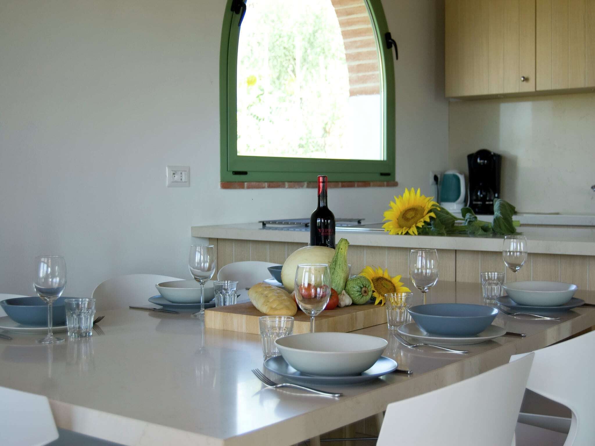 A modern kitchen with a dining area set for a meal.