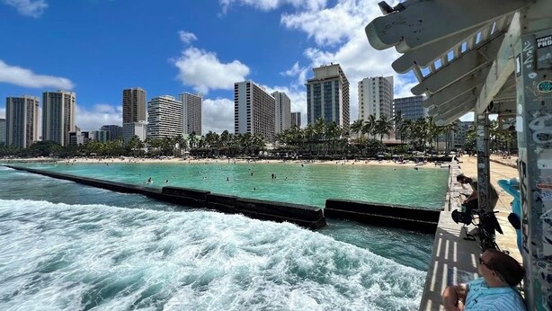 A coastal cityscape with high-rise buildings, a beach, and a pier extending into the water. - 3 Minute walk to famous Waikiki beach 100% legal with Free Parking  (Honolulu)
