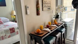 A breakfast setup with orange juice, a bottle of alcohol, and a sign that says "BEACH". - 3 Minute walk to famous Waikiki beach 100% legal with Free Parking  (Honolulu)