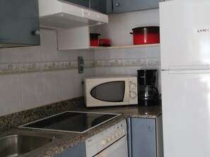 Enjoy cooking in this well-equipped kitchen with a microwave, coffee maker, and stainless steel sink.