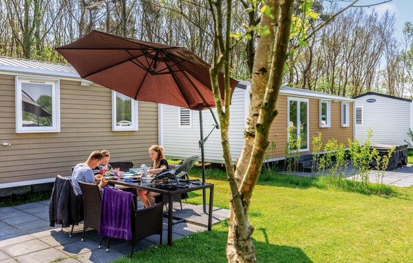 Enjoy al fresco dining on the patio with a table, chairs, and grill.